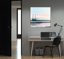 Load image into Gallery viewer, Muted blues and blush pinks wash over Dublin Bay as the iconic Poolbeg Towers stand against the morning light, their reflection shimmering in the ebbing tide.
